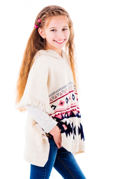 Adorable little girl in warm beige poncho