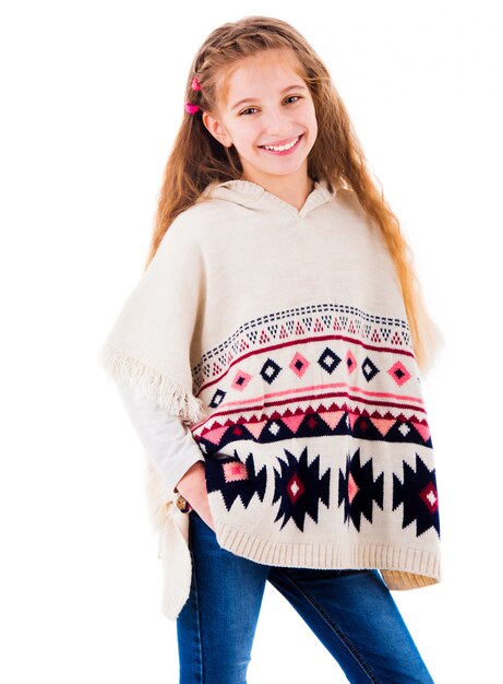 Adorable little girl in warm beige poncho