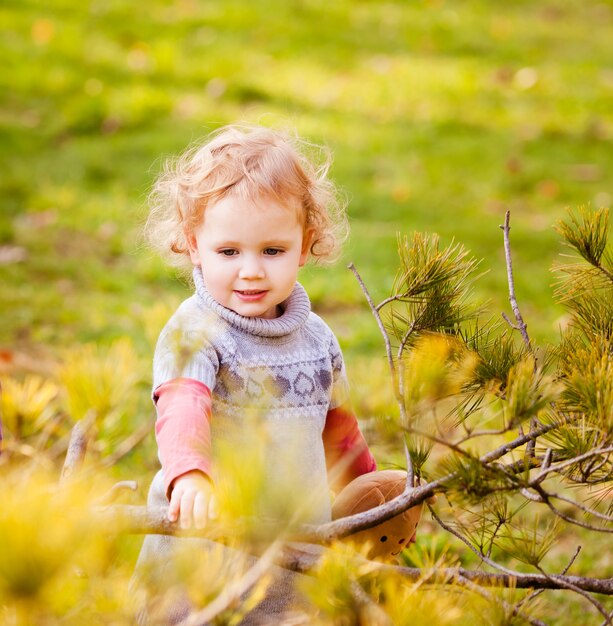 Adorable little girl with autumn leaves