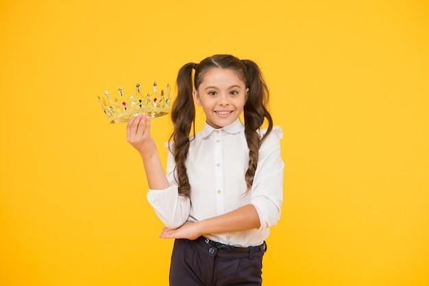 Adorable small child crowned champion girl Happy little winner coronation Beautiful princess Just best Princess life Symbol of luxury Small princess Queen of class School competitions concept