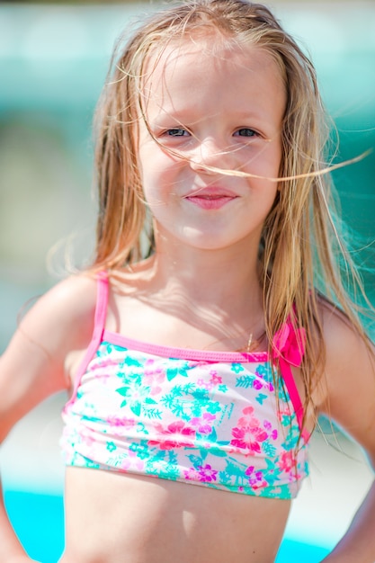 Adorable smiling little girl on beach vacation