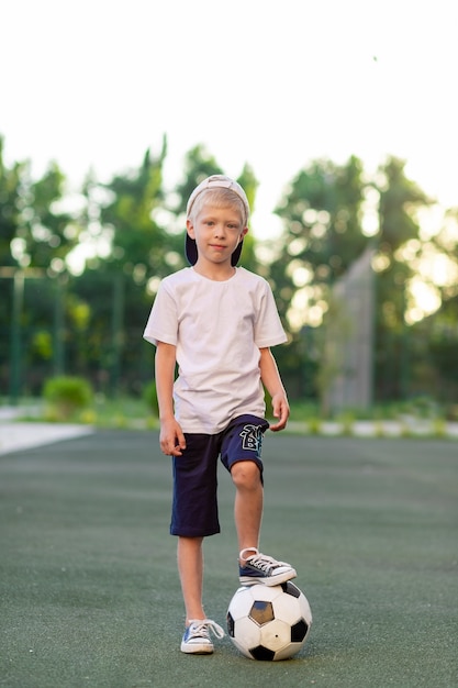 Adorable sporty child on the football field