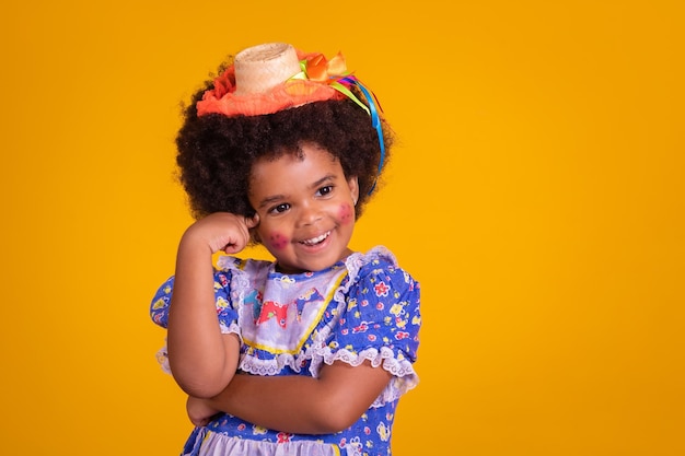 Adorable thoughtful little Afro girl dressed in Festa Junina outfit