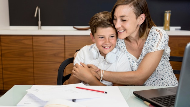 Adorable young boy playing with his mother