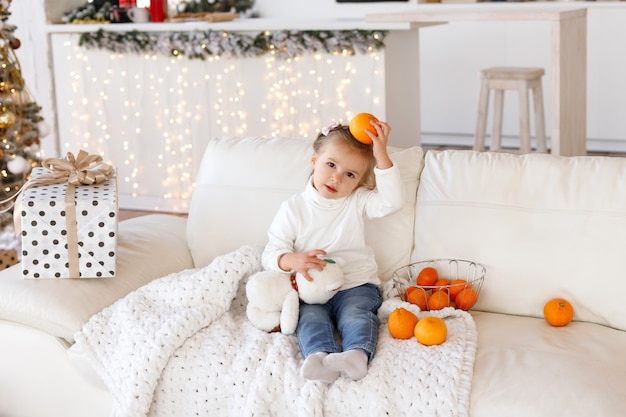 Adorable young girl playing with oranges