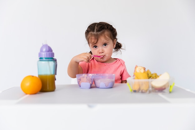 Adorable young girl serving breakfast