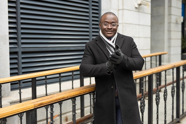 adult african man with glasses in black coat