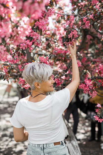 adult caucasian female aged in a blooming garden