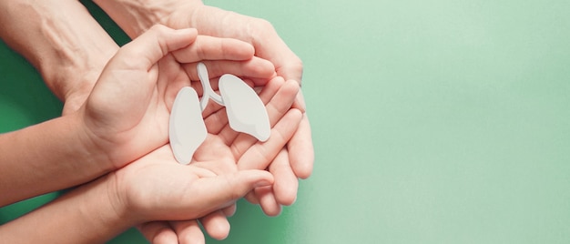 Adult and child hands holding lung, world tuberculosis day