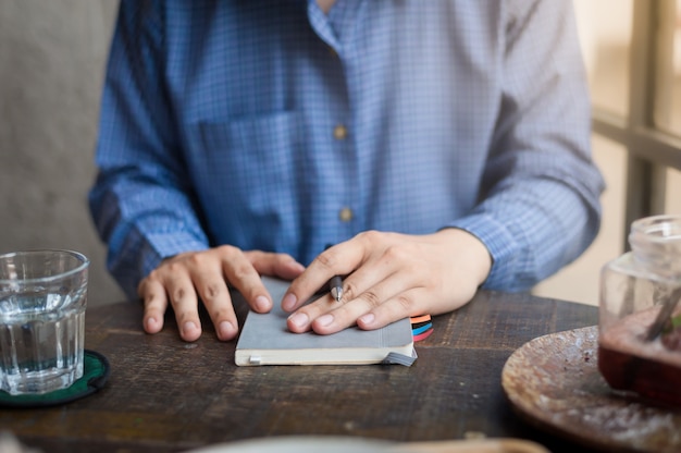 Adult freelance businessman writing on notebook