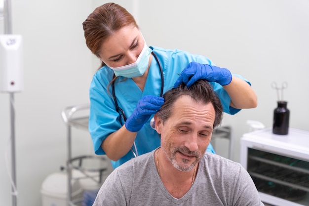 Adult male getting a hair loss treatment