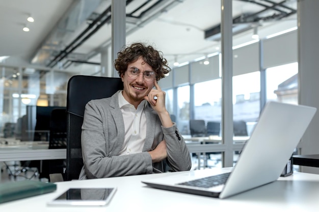 Adult male office worker displays professionalism and experience at his desk radiating contentment