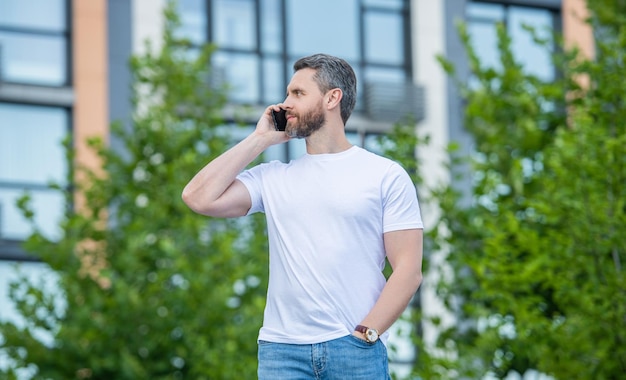 Adult man has phone call outdoor man having phone call in the street man call