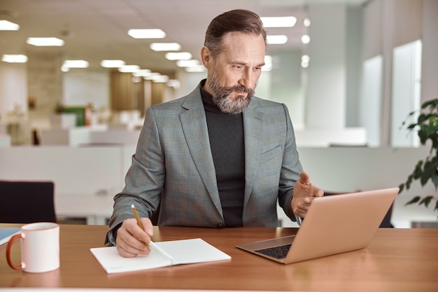 Adult man is working in a modern office