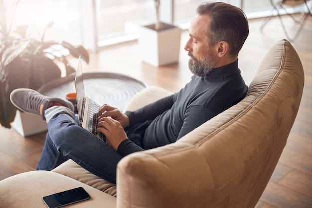 Adult man is working in a modern office