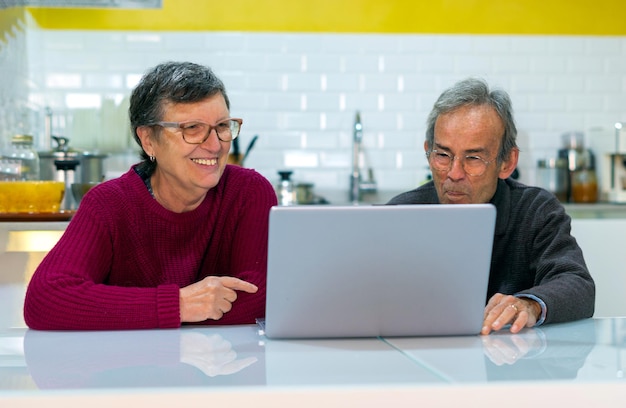 Adult man and woman looking at laptop screen