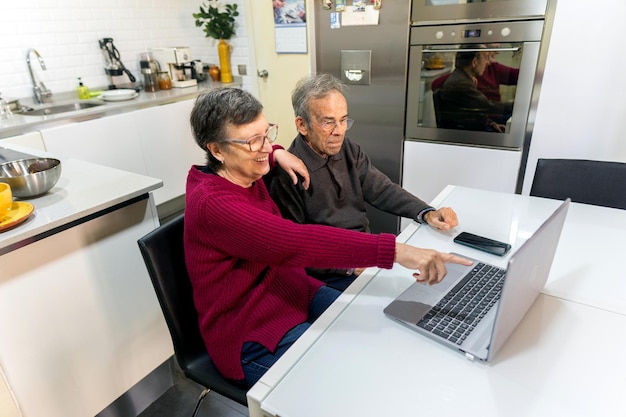 Adult man and woman looking at laptop screen