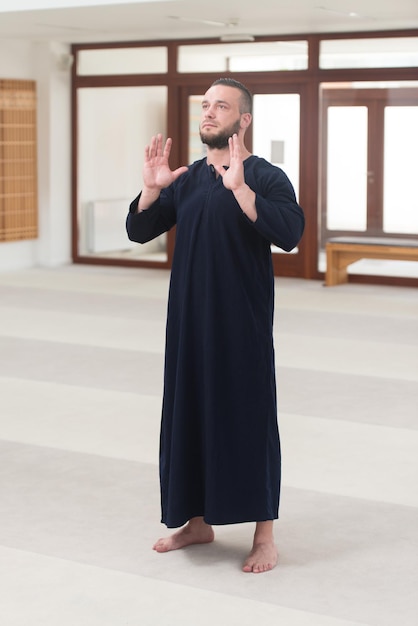 Adult Muslim Man Is Praying In The Mosque