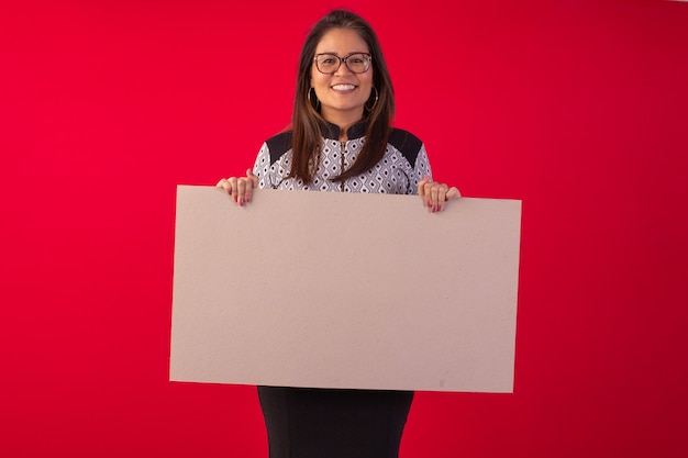 Adult oriental woman wearing formal wear in studio photo with red background.