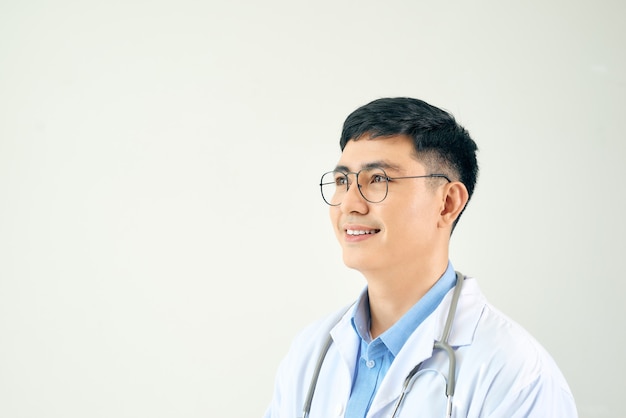 Adult scientist or doctor man wearing white coat over isolated wall looking away to side with smile on face