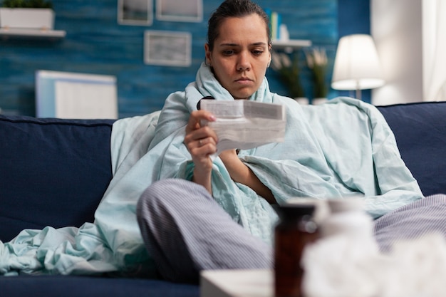 Adult woman holding prescription medicine from pharmacy