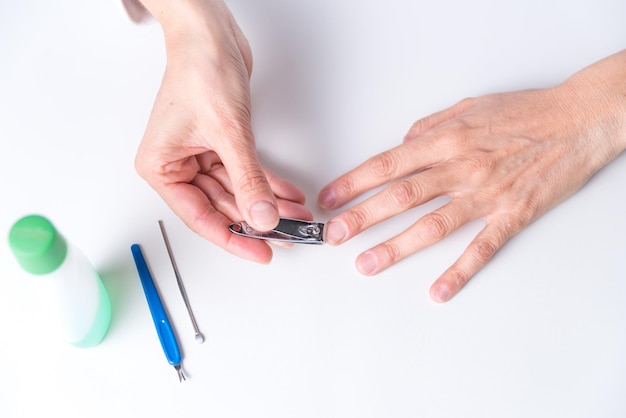 Adult woman's hands doing a manicure at home neutral colorsxA