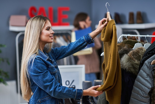 adult woman shopping for clothes in the city center in autumn