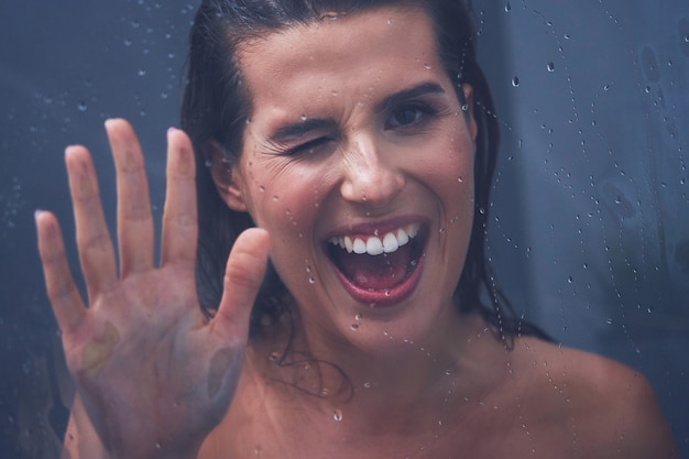 Adult woman under the shower in bathroom