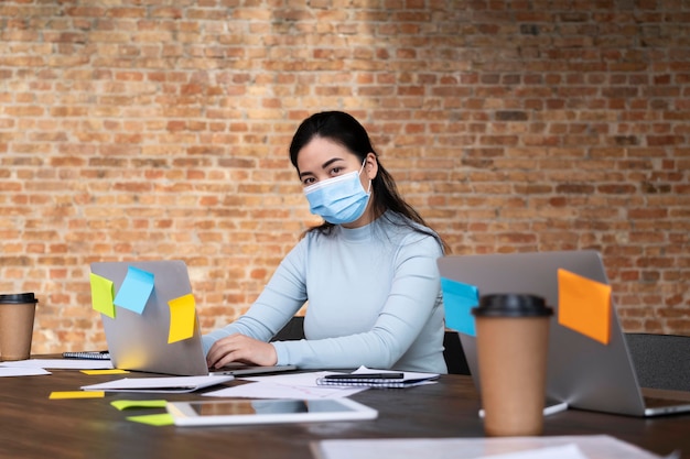 Adult woman wearing a face mask at the office