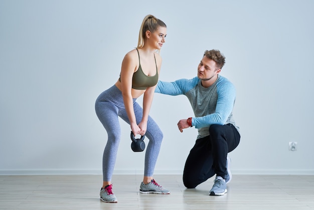 Adult woman with her personal fitness trainer