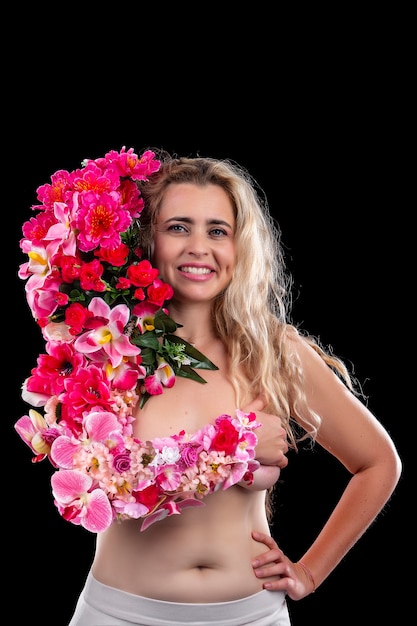 Adult young woman with arm covered in flowers symbolizing mother earth concept over a black.