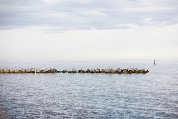 Advanced seawall in the sea breakwater drawing the horizon at sunset on the coast