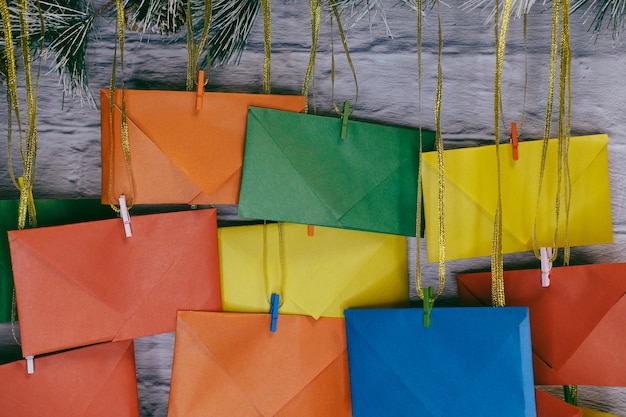 Advent calendar on a background of a brick wall. Multicolored envelopes made by hand.