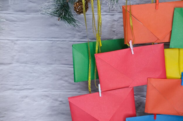 Advent calendar on a background of a brick wall. Multicolored envelopes made by hand.