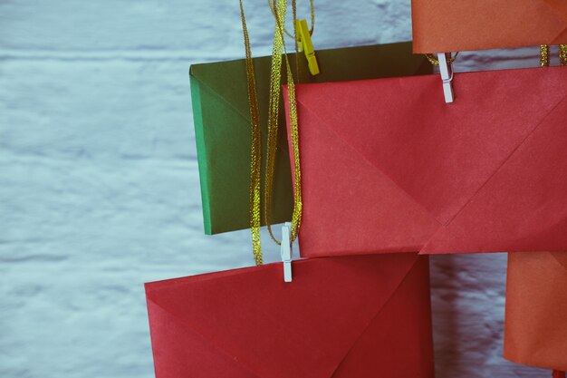 Advent calendar on a background of a brick wall. Multicolored envelopes made by hand.