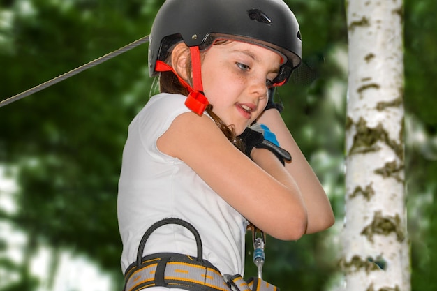 adventure climbing high wire park people on course in mountain helmet