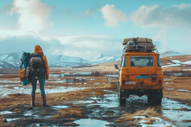 Photo adventurer with backpack standing near a rugged offroad vehicle