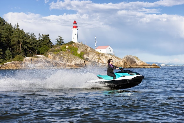 Adventurous caucasian woman on seadoo riding in the ocean