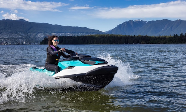 Adventurous caucasian woman on water scooter riding in the ocean