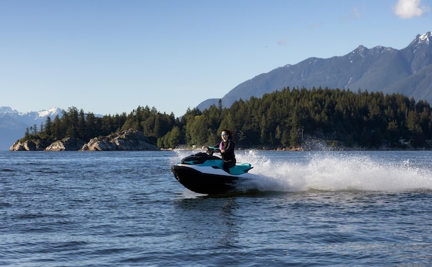 Adventurous caucasian woman on water scooter riding in the ocean