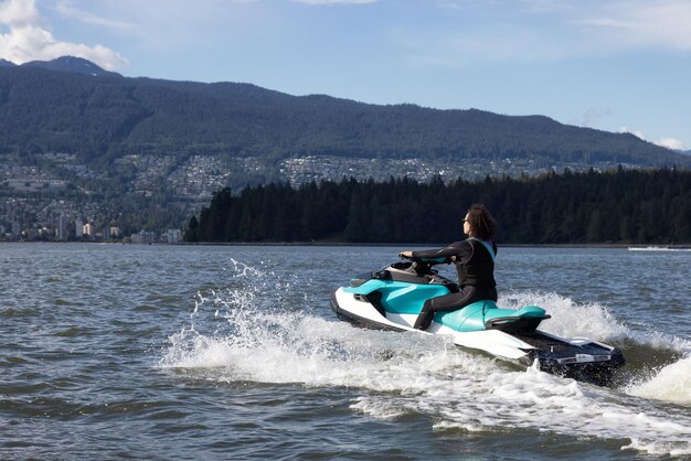 Adventurous Caucasian Woman on Water Scooter riding in the Ocean