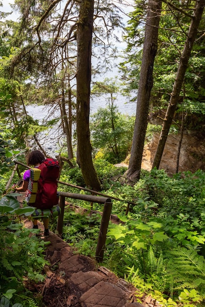 Adventurous girl is hiking Juan de Fuca Trail