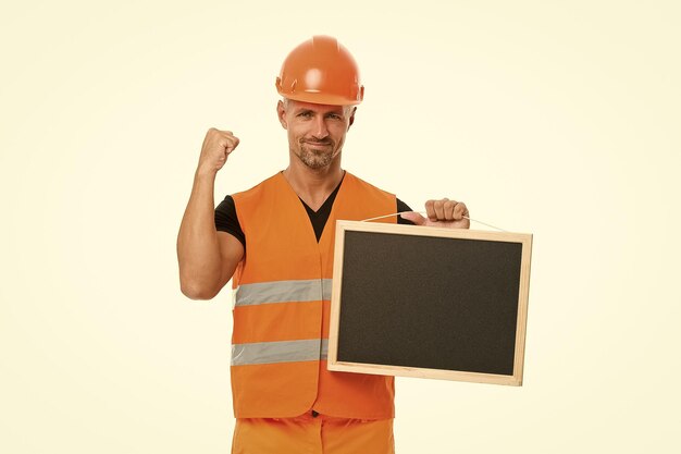 Advertisement concept Builder enjoy success Strong handsome builder hold blackboard Successful engineer Man protective hard hat uniform white background Worker builder confident and successful