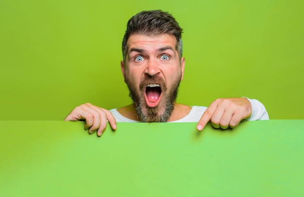 Advertisement surprised man with blank poster businessman holds empty placard bearded man holds