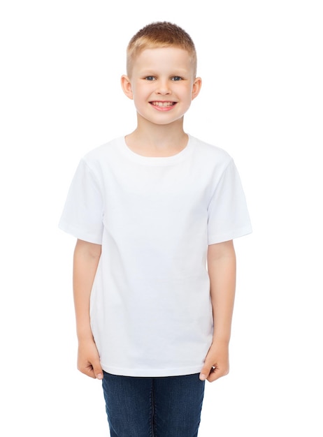 advertising, people, childhood and t-shirt design concept - smiling little boy in white blank t-shirt over white background