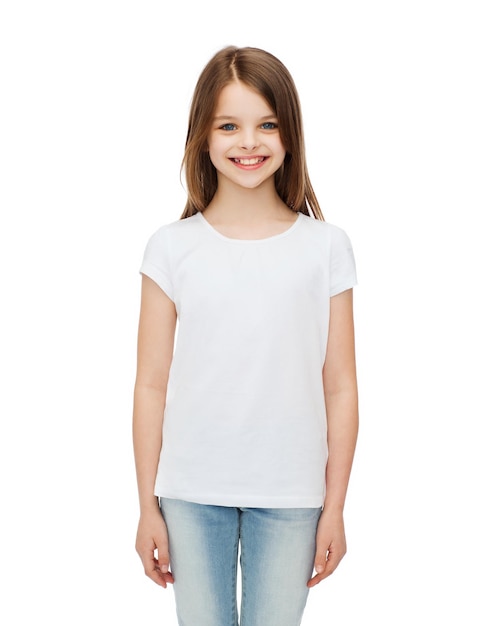 Photo advertising and t-shirt design concept - smiling little girl in white blank t-shirt over white background