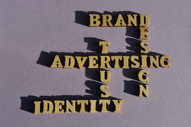 Photo advertising trust identity brand design words in wooden alphabet letters in crossword form isolated on background