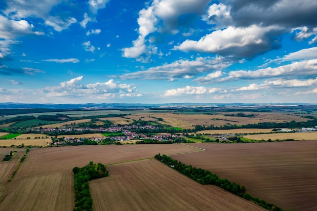 Aer ial view of a German village surrounded by meadows farmland and forest in Germany