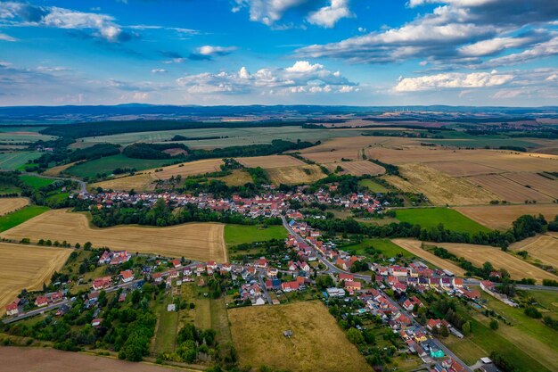 Aer ial view of a German village surrounded by meadows farmland and forest in Germany