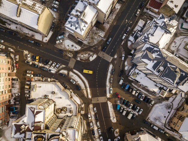 Aerial black and white winter top view of modern city with tall buildings